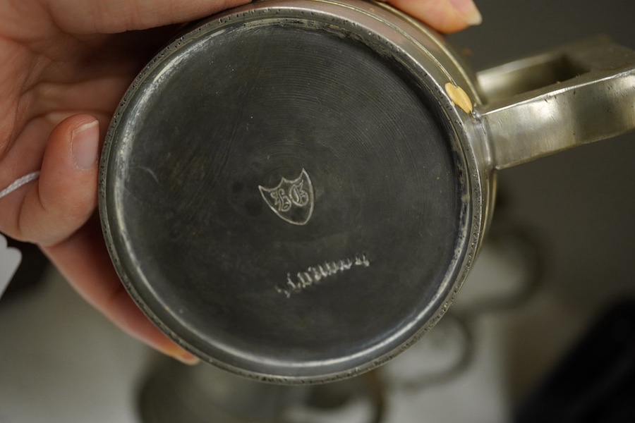 A collection of 18th and 19th century pewter mugs and other items including a 19th century wine bottle, bottle 27cm high. Condition - fair